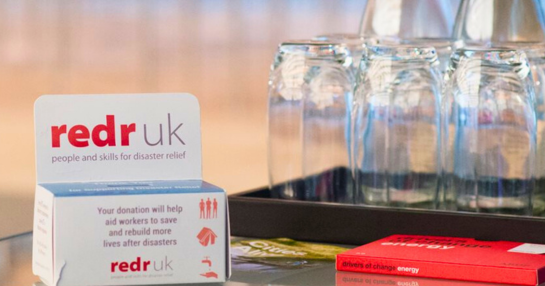 Image of RedR cardboard donation box at a fundraising event. Image of RedR cardboard donation box at a fundraising event.