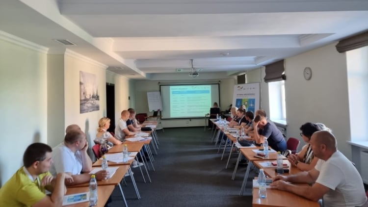 Participants sitting around a table during a training.